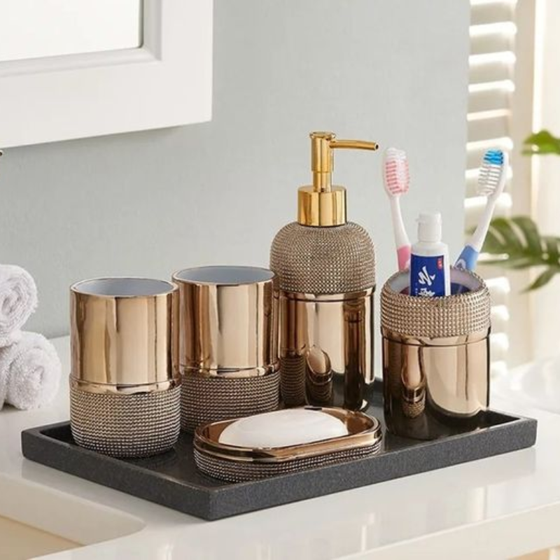 um kit banheiro metálico na cor bronze